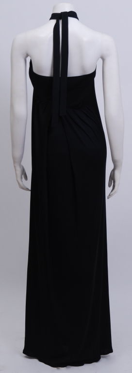 Black silk jersey wrap dress. This early design of Mr. Beene's is unique with it's cris-cross wrap in the back which follows through the front, tying in the back. A simple, elegant, timeless, sexy silhouette.<br />
<br />
Geoffrey Beene was born