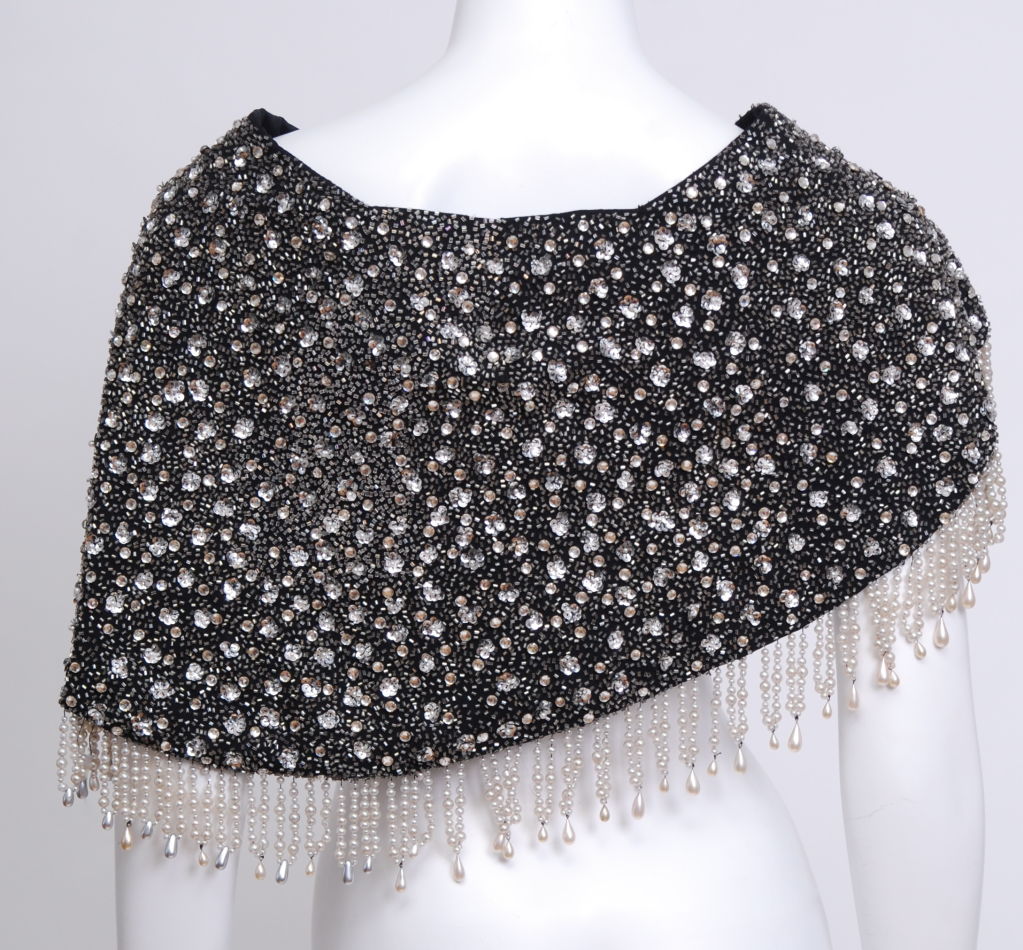 Black silk caplet embellished with a multitude of glass metallic beads, rhinestones and faux pearls.