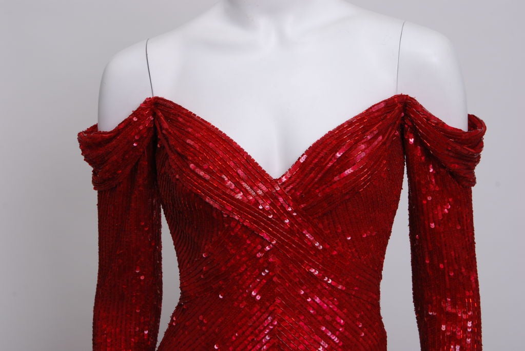 Red carpet, couture worthy showstopper. Bias cut, corseted bodice, draped shoulders, long sleeves zippered at wrist, fully lined in silk, hand beaded glass bugle beads and sequins throughout. 

 Robert Gordon Mackie was born on March 24, 1940 in