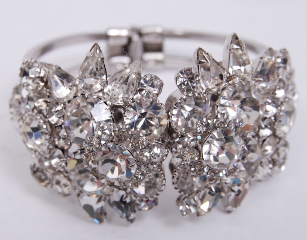 Cluster of large, assorted shape crystal rhinestone cuff with spring in the middle back to open. Crystals and metal of the bracelet has been kept in mint condition.