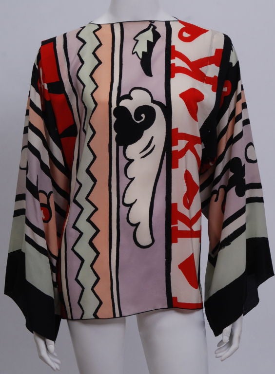 Full cut kimono sleeve silk king of hearts tunic style blouse. Single, silk covered button at back top neck.<br />
<br />
Michaele Vollbracht, born 1947 in Quincy, Illinois, is a fashion designer who has worked both under his own name, and also as