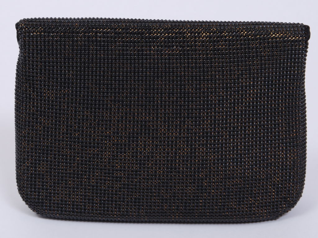 Unused gold metal mesh with black glossy domed enameled coating. Black satin lining and exterior piping.  Kept in pristine condition, this clutch is the perfect evening addition to any wardrobe.