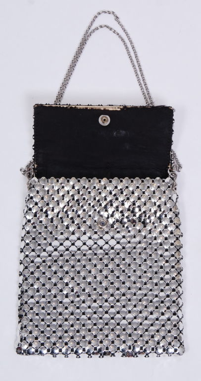 Shiny domed metal disk mesh with long silver chain strap. Fully lined in silky black lining. Singular interior pocket. Adjustable strap to take this bag from day to night.<br />
<br />
Chain  20 inches long