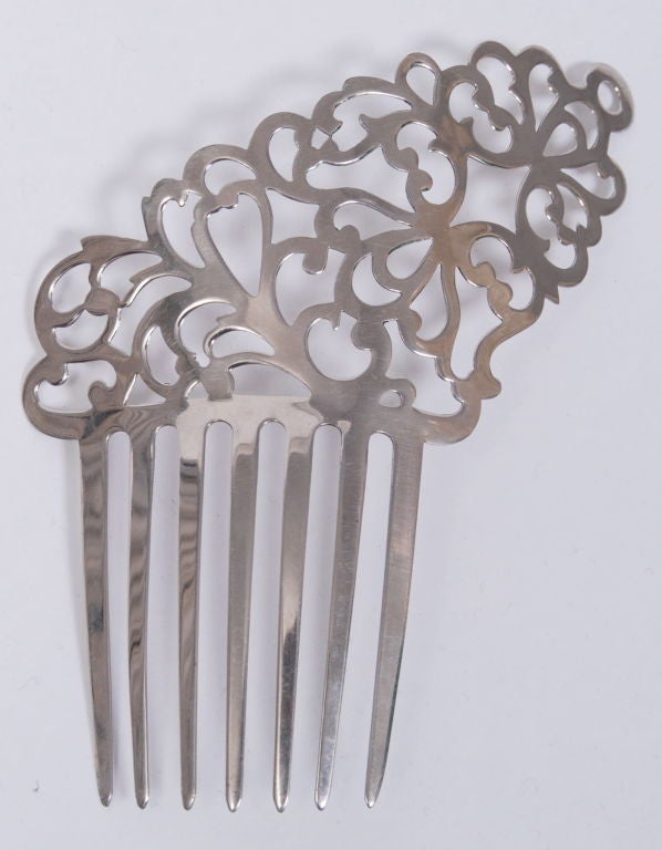 Silver colored metal, intricately cut hair comb.Kept in impeccable condition.