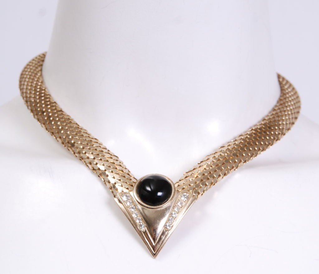 Gold mesh choker with polished black stone and rhinestone detail. Easy evening accessory to compliment this spring's luxe gold trends.