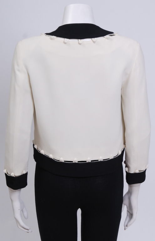 Black and cream silk crepe matador style jacket with button detailing. Fully lined. Mint condition.