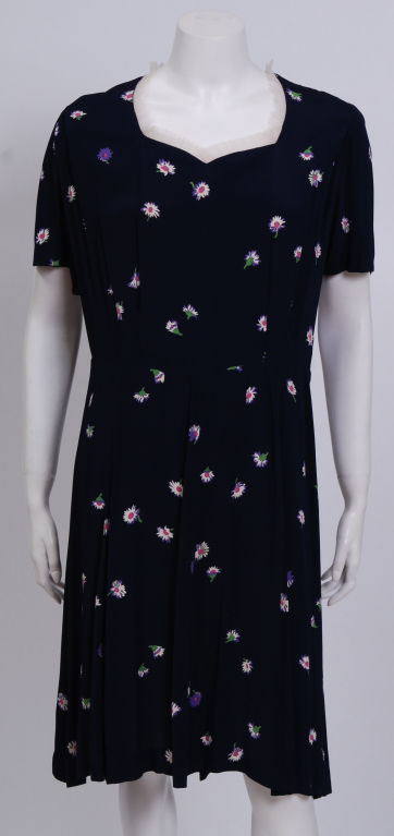 Navy blue 40's day dress with small white and hot pink flower motif.<br />
<br />
Debbie Harry began her musical career in the late 1960s with folk rock group The Wind in the Willows and later joined The Stilettos in 1974.  She then formed the