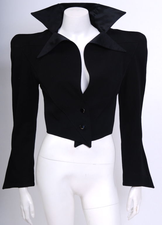 Early Thierry Mugler Gold Label jacket. Exaggerated Silhouette, pyramid shaped shoulder pads, nipped waist, cut crystal buttons, knife cut silk satin lined collar, v shaped detail at back. Fully lined in black silk.