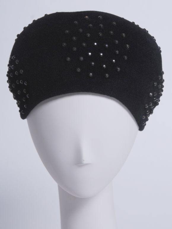 Black beaver felt hat decorated with charcoal colored gunmetal nail-head studs. Size medium.