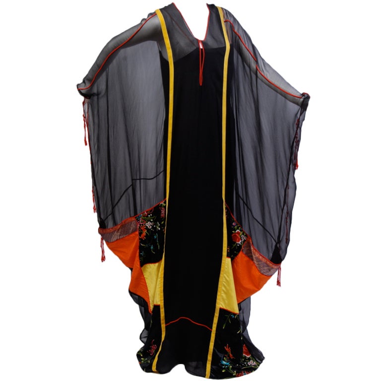 One of a kind, Thea Porter Couture caftan. Pieced of silk chiffon, natural silk and silk satin Asian embroidery. Decorated with red silk cord piping, and tassels. Black silk slip underlay. The slip fits a size 2-6, and can be changed out for any