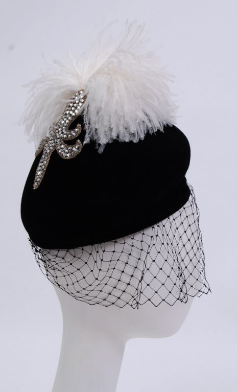 Jack McConnell hand crafted black felt hat decorated with crystal rhinestone fleur de lis , ostrich feather pouf and veil. Can be worn with or without veil.