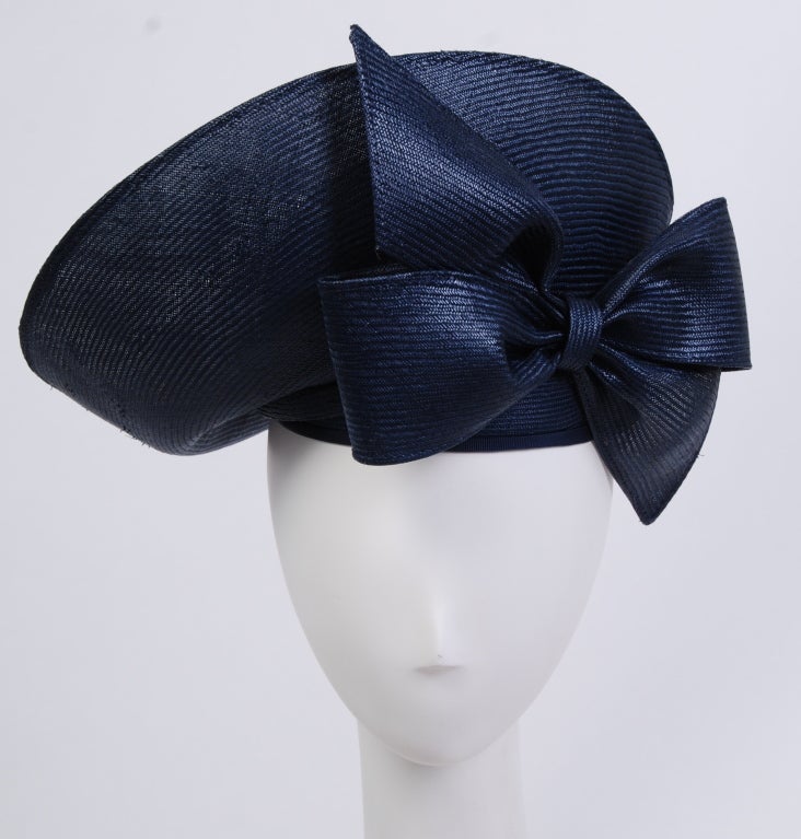 Boldly designed, sculpted shiny navy blue straw hat. Designed by the late expert milliner, Jack McConnell. Accompanied with original box.