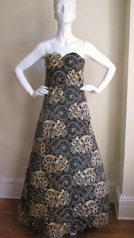 Stunning vintage 1960's gown from former Charles James apprentice, Arnonld Scaasi in beautiful black and gold silk cut work embroidery on a firm black net background.  Bustier style with an inner boned corset and grosgrain waistband to hold the