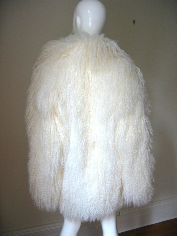 Beautiful white of Mongolian Lamb fur jacket.  Fully lined with side seam pockets and hook closure.   
Brand new, never worn.Size Medium

Bust  39