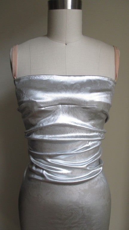 Beautiful silver stretch silk dress with a subtly embossed abstract design of flowers and leaves.  Bodice is ruched front and back to the waist then fitted to the hem.  Flesh tone adjustable straps attach to a hidden mesh bra for support.  Back