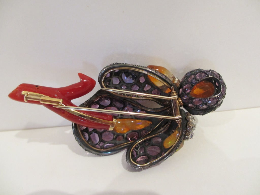 One of a kind.
Iris Flower Brooch comprised of Purple Sapphires, Jelly Opals, Diamonds, and Red Coral. Handcrafted.
49.75 carats of Natural Color Purple Sapphires
9.38 carats of Jelly Opals
1.66 carats of Diamonds