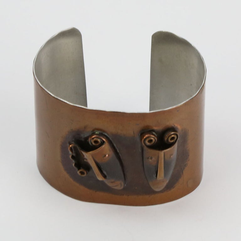 Modernist Copper Cuff Bracelet, featuring applied Comedy ‘n Tragedy masks, signed REBAJES; by famed Mid-Century Dominican-Manhattan jeweler, Francisco Rebajes.  
