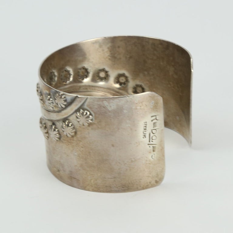 Modern and Chic Sterling Cuff Bracelet by Francisco Rebajes with streams of flora in relief the cuff measures approx. 1.5” wide; the opening approx. 1” and fits an average wrist. Signed: Rebaje with a stylized sideways number 8 STERLING C1950s