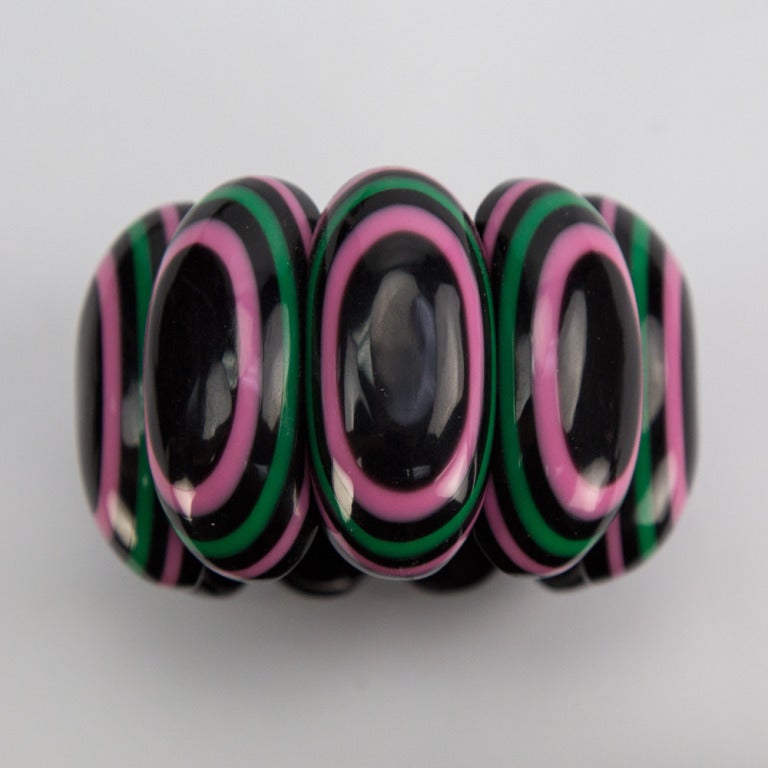 Dramatic Ovals of Band within a Band Bracelet, crafted in Hot Pink, Green and Black Celluloid. Add Pizazz to any Outfit and Light up a smile for Special Someone, including You! Elasticized, to fit a small, average and large wrist.