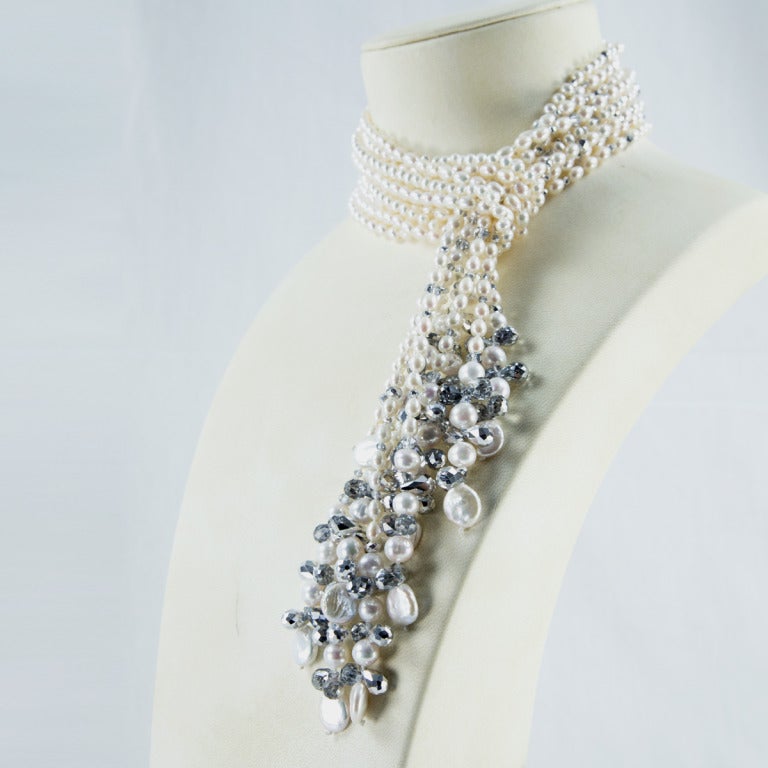 Sensational five strand Necklace comprising White Pearls of various shapes and sizes accented by silver and clear Crystals; can be worn as a single, double, triple strand or all together, making a statement, so reminiscent of the roaring 1920s! A