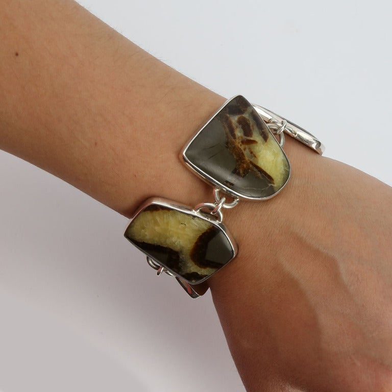 Dynamic Sterling Silver Toggle Bracelet; each large uniquely shaped surround is set with a Landscape Agate; Marked: STERLING; approx length of bracelet: 7.5”
