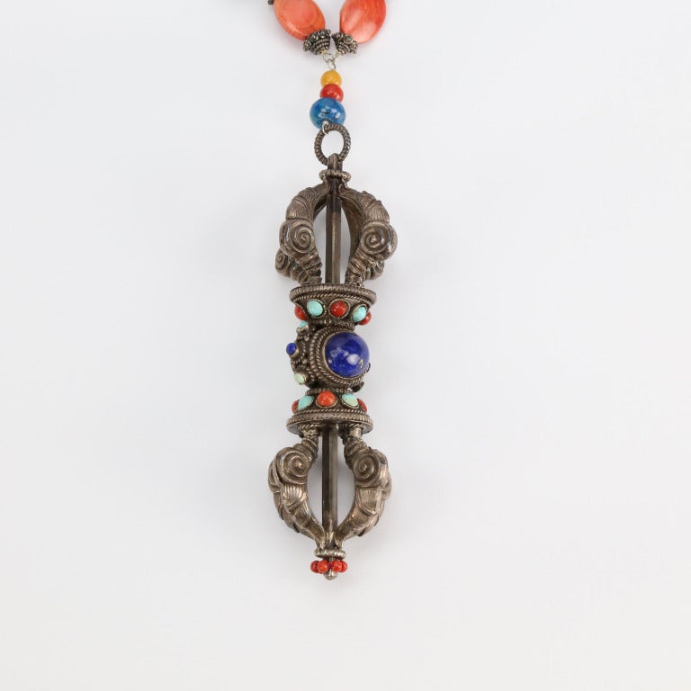 Fabulous One-of-a-Kind Necklace comprising natural Turquoise, Coral, Lapis Lazuli, agate and bone in varying shapes and sizes inter-spaced with silver elements, suspending a Tibetan Sterling Silver Dorje set with lapis lazuli coral and turquoise.