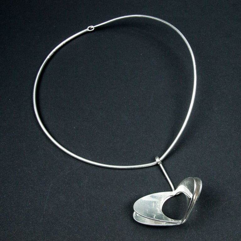 Striking large Mid Century Modern Alton Sweden Sterling Silver pendant suspended from a silver torque; designed by Theresia Hvorslev Marked: ALTON SWEDEN 935 STERLING; Circa 1972; Drop of pendant: 2”; Chic and Timeless … Illuminating your Look with