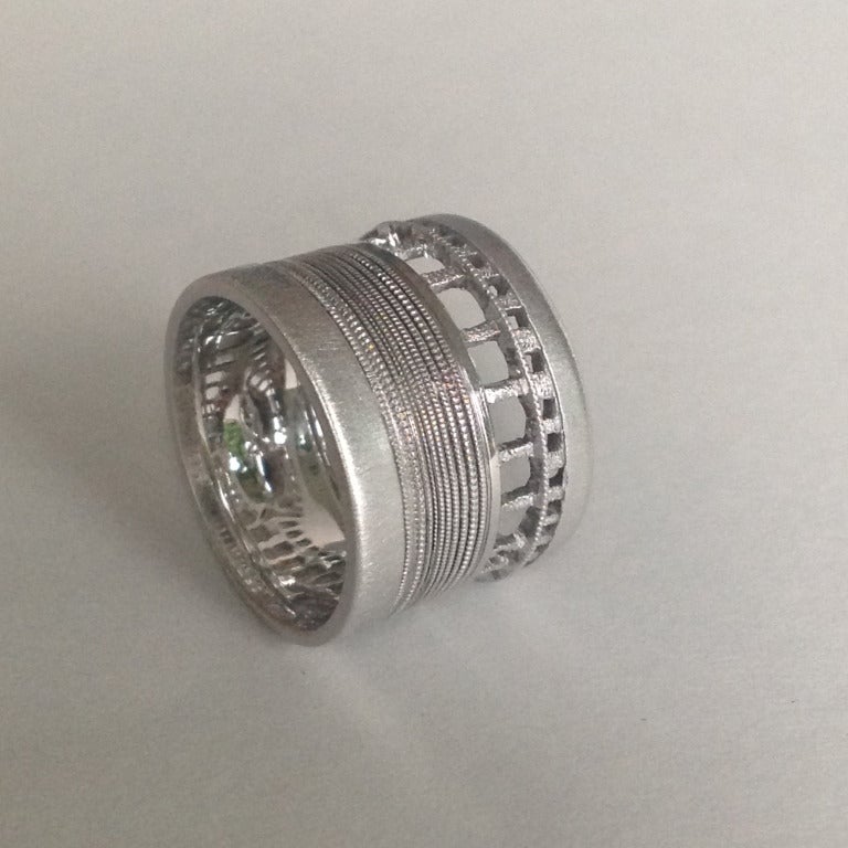 Dalben design 18kt white gold band ring 14.7 mm high, size 7 1/4 USA, 55 EU, resizable.

This unisex band ring is inspired by ancient embroidery on linen tissue.

The ring is completely hand made in our atelier in Como, Italy.