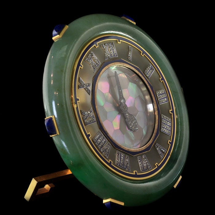 Beautiful and rare desk clock of Oriental inspiration the circular dial inlaid with tessellated mother-of-pearl, with royal blue enamel details and diamond set hands, to a rock crystal bezel applied with diamond-set Roman numerals, set within a
