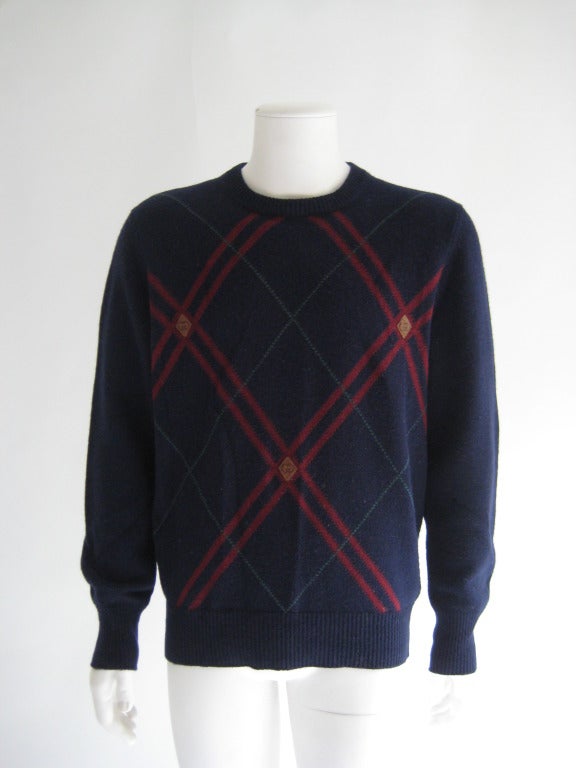 Mens Gucci, Italy Sweater. Leather accents on front that are embossed with Gucci Logo. 100% Lambswool. Tag reads 50 (EU size) = US size 40 or Large.