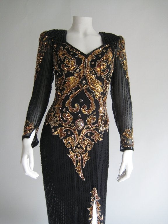 100% Silk Beaded, Sequin formal full length dress/ gown. Padded shoulders. Black fringe on shoulders. Keyhole back. Zip up back. Hook and eye at back of neck. Silk lining.Tag reads size 6.