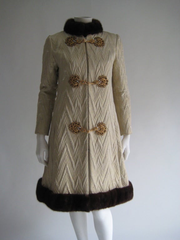 1960s Oscar de La Renta Coat. Mink fur trim. Gold and rhinestone decorative front closures . Front zipper. Front hand pockets. Fully lined. Silk fabric with gold metallic threads throughout entire piece. There is not a size tag however it would be