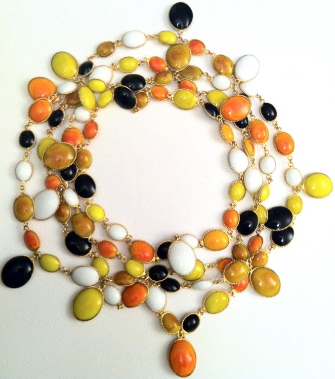 Extremely rare, 80 inch long single strand necklace made for Jacques Fath in the 1950s by Gripoix, of poured glass in delicate shades of amber, yellow, peach and apricot, with black and white accents, set in gilded metal. 1950s Haute