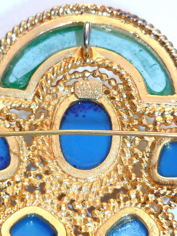 Large and rare pendant brooch made in 1971 by Henkel and Grosse for Christian Dior from a Robert Goossens design. Consists of a gilded metal setting with faux lapis and jade cabochons, hung with three matching pendants. The brooch replicates an
