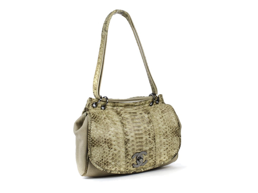 The best of both worlds! Take this bag from desk to drinks in no time! Chanel bag is adorned with a natural skin python as well as beige natural cotton throughout the back of the bag and corners to ensure this bag will last you! Interior features