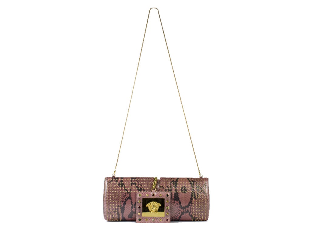 Gorgeous & hard to find vintage Gianni Versace snakeskin bag which previously belonged to Kimberly Stewart. Gorgeous studded detailing throughout, delicate gold tone chain detailing, pink snakeskin, removable mirror with Versace symbol and