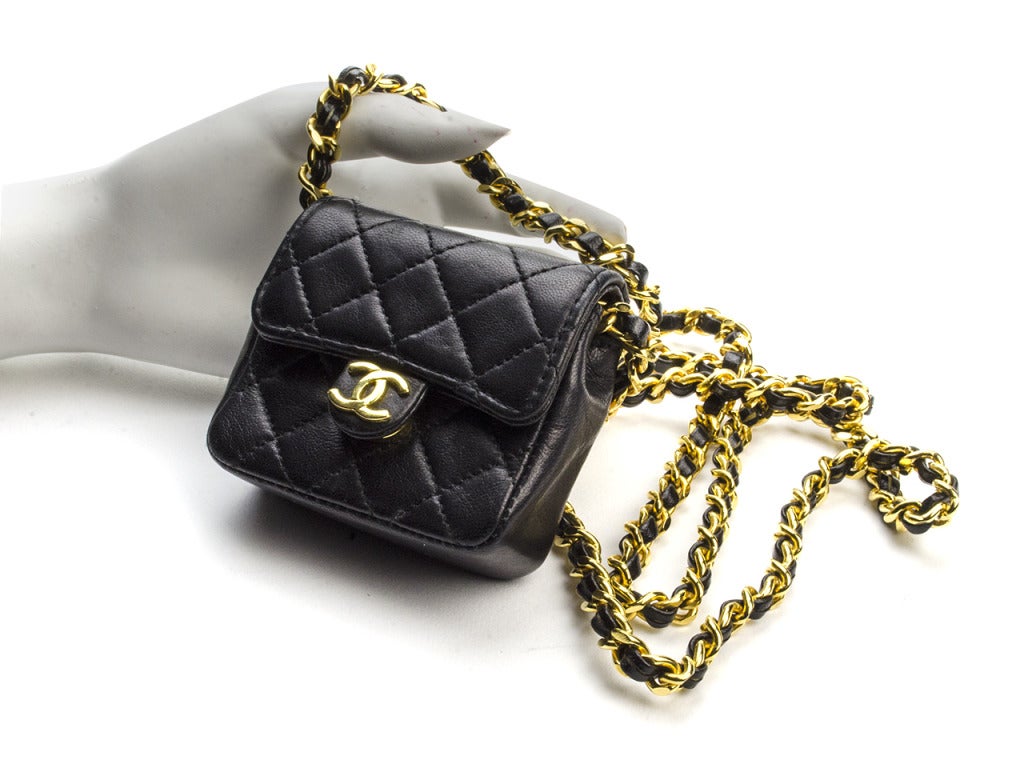 Perfect as a girl's first Chanel or a unique addition to an existing collection, the black micro mini flap screams two words: Super cute! Quilting embroidery and a mini interlocking CC charm give it the quintessential kiss of none other than Chanel.