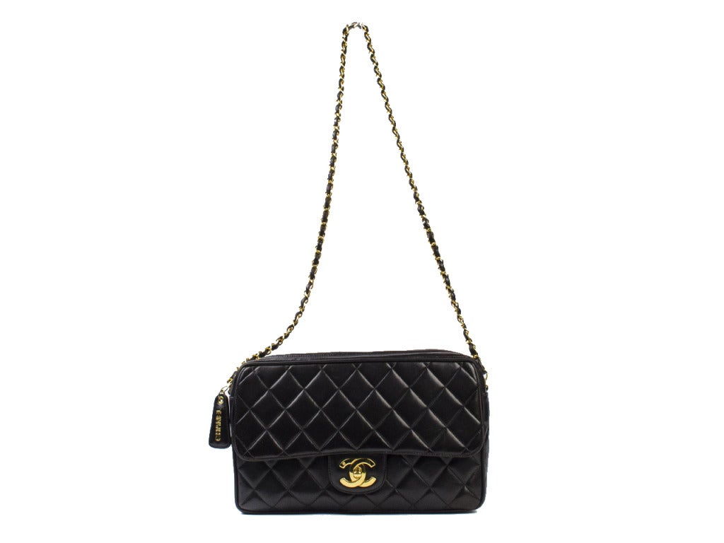 A Chanel crossover this bag offers the best of both worlds! Zips shut so things aren't flying everywhere when you have to slam on your breaks with the appeal of the flap at the front. Chanel leather medallion pull with goldtone hardware, single