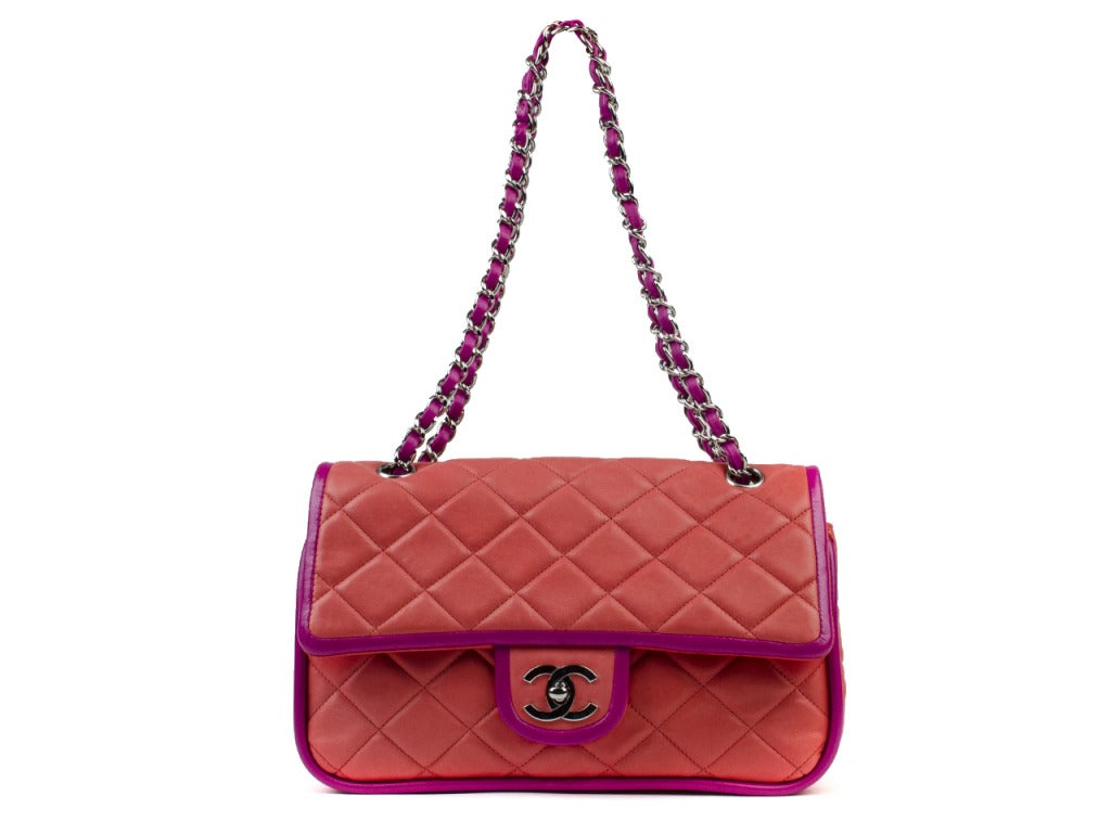 Your winter denims and summer whites will look equally stunning when paired with the vibrant Chanel quilted orange flap bag with purple piping and straps. Silver interlocking CC icon is featured on clasp and opens up to a gorgeous soft leather inner