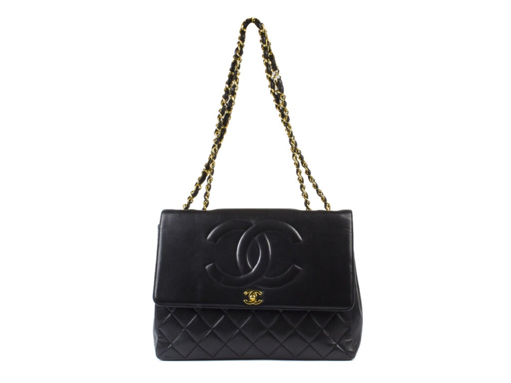 Channel your inner Gatsby with the Chanel black quilted CC large flap bag. The structured shoulder bag won't be mistaken for anything but authentic luxury with large interlocking CCs embossed on the flap and gleaming in gold on the clasp underneath,
