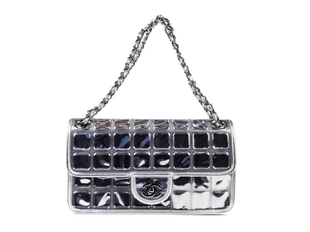 Glam up your favorite LBD with layered necklaces, a belt at the waist and the Chanel mirrored flap. This glitzy twist on Chanel's classic bag features a mirrored square pattern atop silver pummeled fabric on front and back, with quilted silver