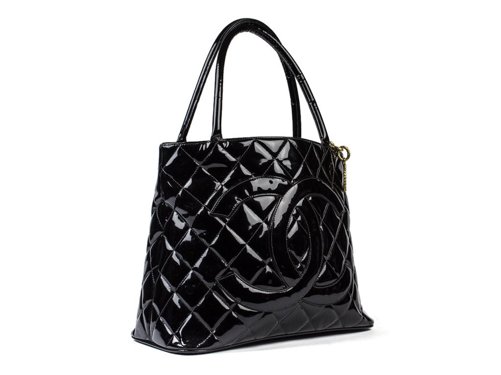 The quintessential Chanel Medallion Tote is the perfect everyday bag and can be used as a great bag to start your future Chanel collection! Quilted patent leather throughout, gold tone hardware at zipper pull and medallion. Interior features one