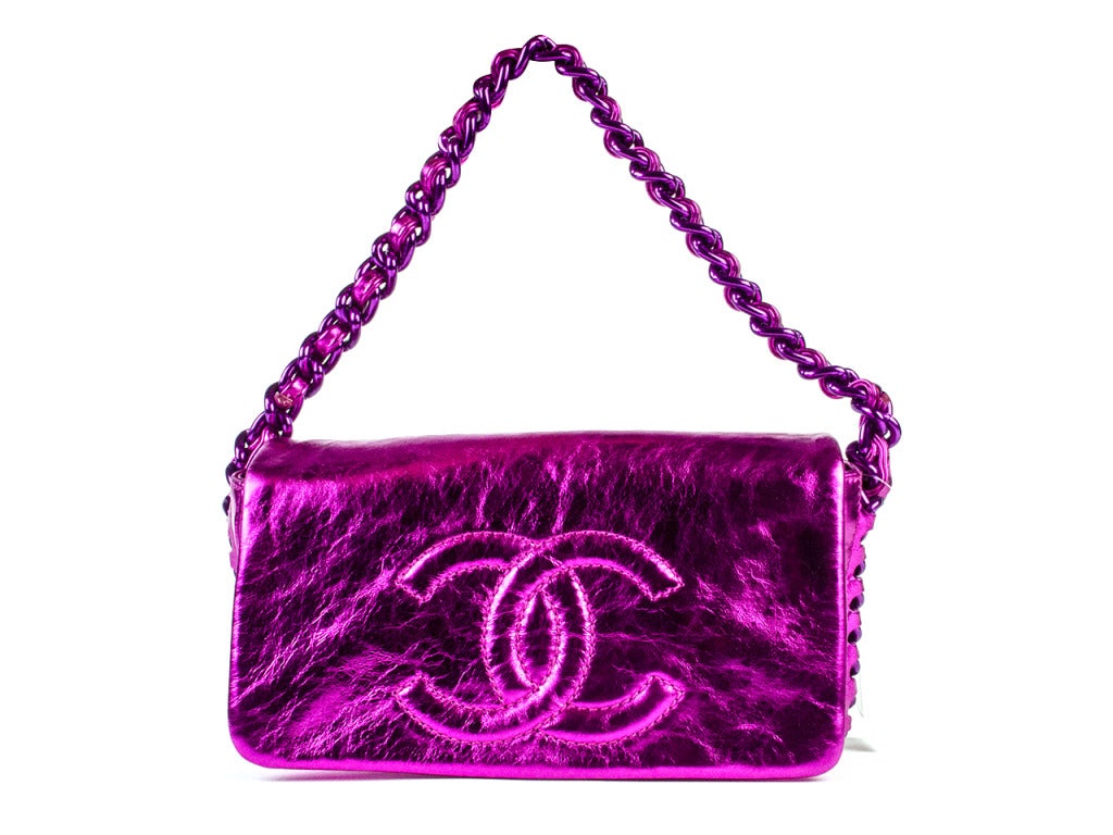 You'll shine like you just stepped off a Hollywood set when you add the Chanel fuchsia pink flap bag to a nude bandage dress and strappy metallic heel and step into your favorite nightclub next Saturday night out. Large embroidered interlocking CC