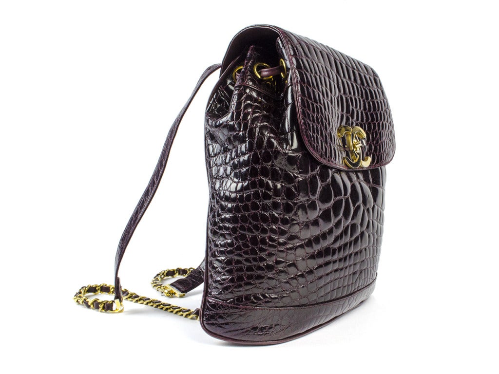 Own the exact Chanel porous crocodile backpack that was modeled by Claudia Schiffer on the Paris runway in 1989! Enough to make any Chanel fan swoon. Exquisitely constructed luxurious deep red-brown crocodile leather accented with yellow gold
