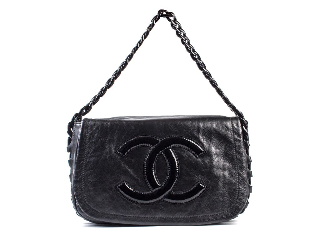 This Chanel modern chain flap has a edgy black chain strap with a leather exterior and large patent leather CC logo on the front of the flap. It is fun and trendy and you will for sure get compliments anywhere you go. H 8