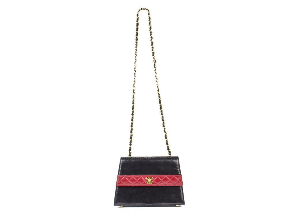Be the epitome of lovely with a billowy blouse, cat eye sunglasses and the Chanel black and red color block bag. Slick leather structured bag features quilted red leather paneling on front, back and sides. A gold interlocking CC charm adorns the