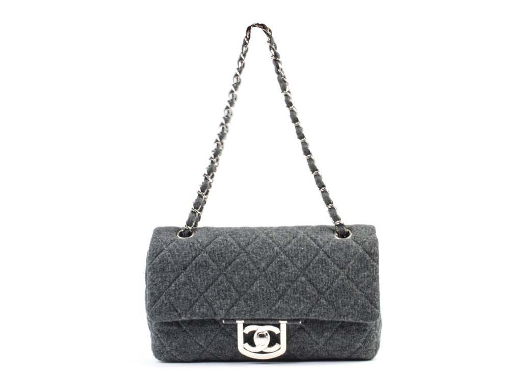Cozy like a flannel but perfect for any outfit is this Chanel quilted bag that is grey with silver accents. It may be comfy, but it is definitely way cuter. H 6