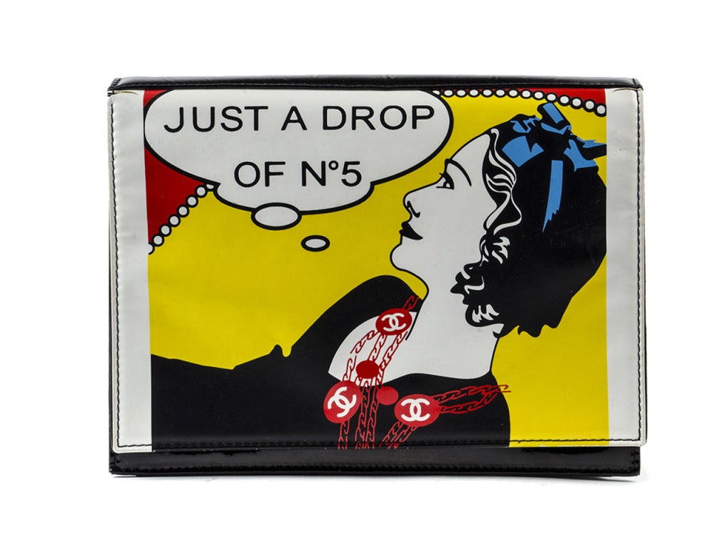 This is an authentic CHANEL Patent Just a Drop of No 5 Comic Coco Clutch. This very chic clutch is crafted of colorful patent leather with a bold frontal print of a comic book style Coco Chanel. The clutch features a black patent leather back, a