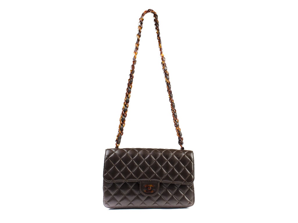 The structured classic with a modern twist! Whether you wear it crossbody or over the shoulder, the Chanel brown and tortoise vintage flap is that rare piece that can be worn as a neutral with prints or a statement with solids. Plush brown quilted