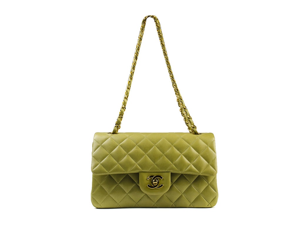 Show the world your colorful side with the sought-after Chanel double flap bag in creamy yellow-green. Features gold interlocking CC turnlock detail and gold hardware strap. Quilted leather exterior flap and body melts into smooth leather interior
